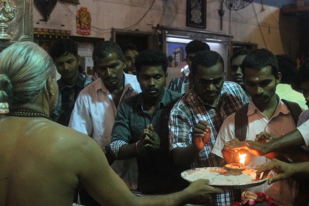 Worshippers rush to take part in the sacred fire custom at Sri Veeramakaliamman.