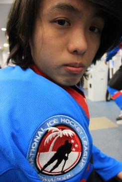 Mark Song shows off his Singapore Hockey League's jersey before hitting the ice for a game. 