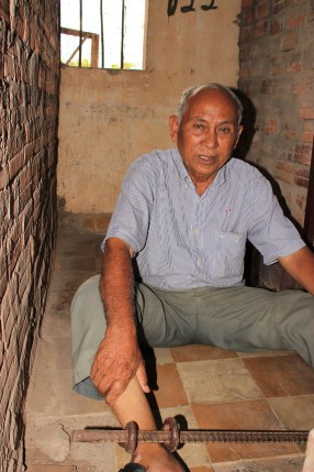 Chum Mey shows the exact cell that he was caged in after his arrest by the Khmer Rouge at S-21 prison. 